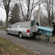 Unloading the casket onto the church truck.